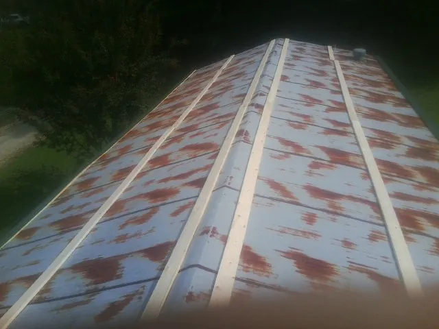 Rusted metal roof panels with new wood purlins before replacement — Storm Damage Roof Repair in Algonquin by Roofing Brothers